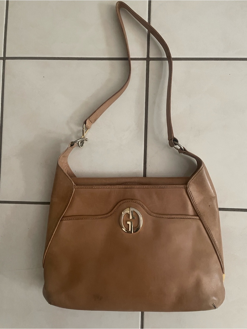 Leather Shoulder Bag with Gold Tone Logo - Tan
Includes authenticity card